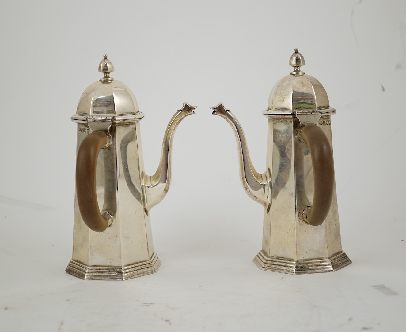 A pair of George V octagonal silver café au lait pots, by William Comyns & Sons Ltd